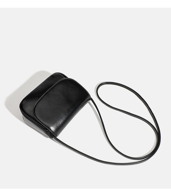 Compact rounded rectangular flap crossbody bag with glossy leather-look finish and long shoulder strap, detail view 20