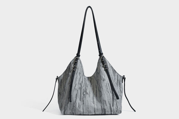 Large slouchy woven-texture shoulder tote bag with slim leather-look straps, side cinch ties, and silver-tone hardware