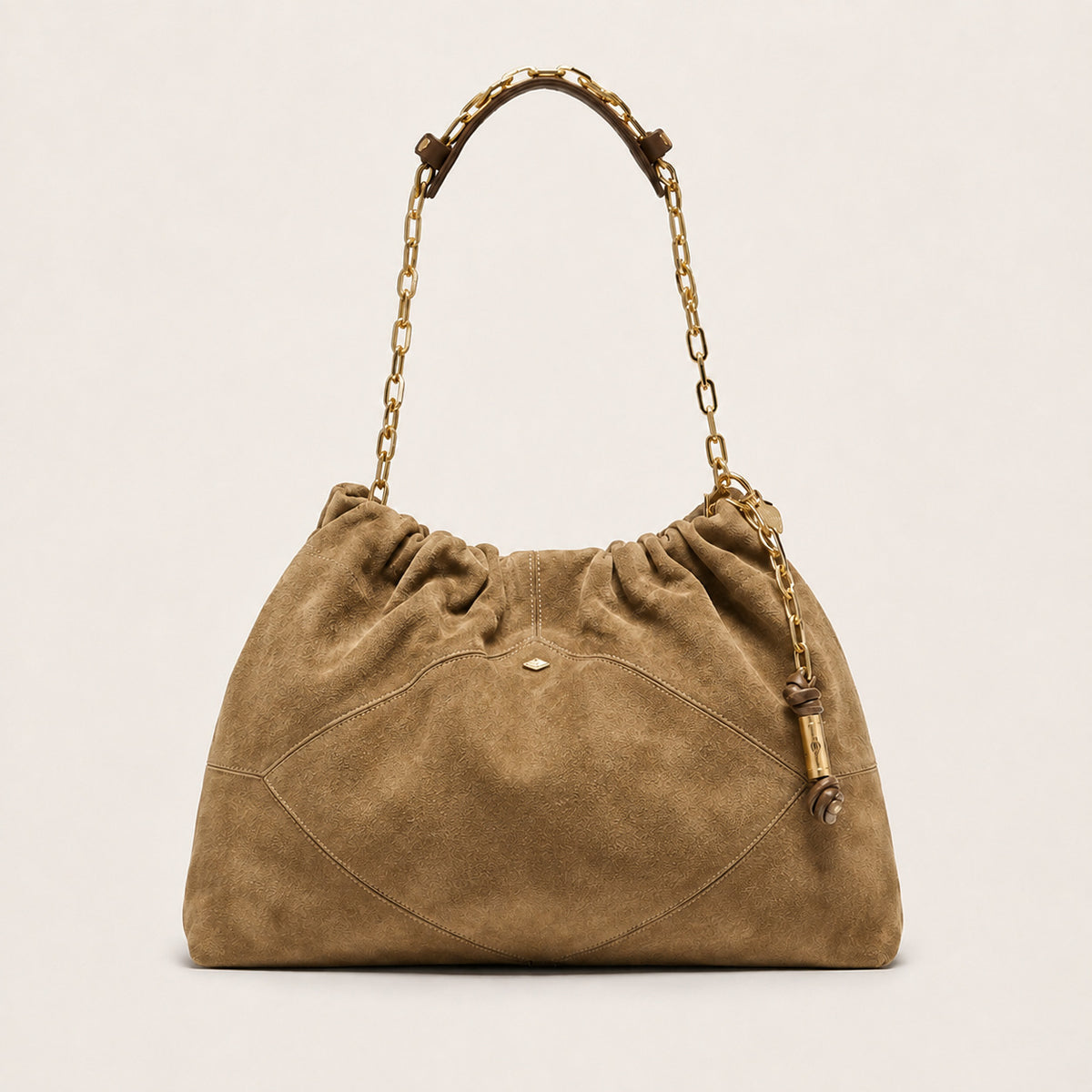 Slouchy suede-look shoulder bag with gathered top, angular stitched paneling, and chunky gold-tone chain strap, front view