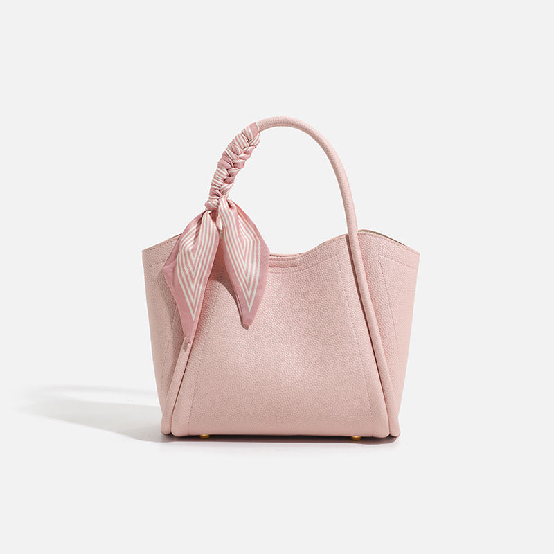 Pebbled leather-look bucket tote bag with scarf-wrapped top handle and gold-tone hardware, detail view 8