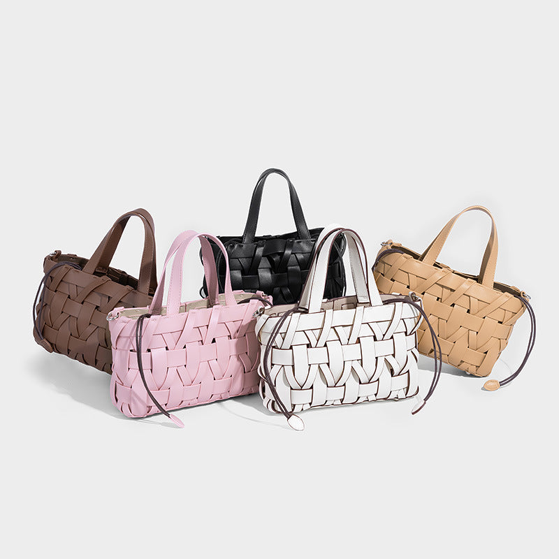 Structured woven basket tote handbag with contrasting dark trim, double top handles, detachable shoulder strap, and