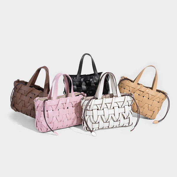 Structured woven basket tote handbag with contrasting dark trim, double top handles, detachable shoulder strap, and