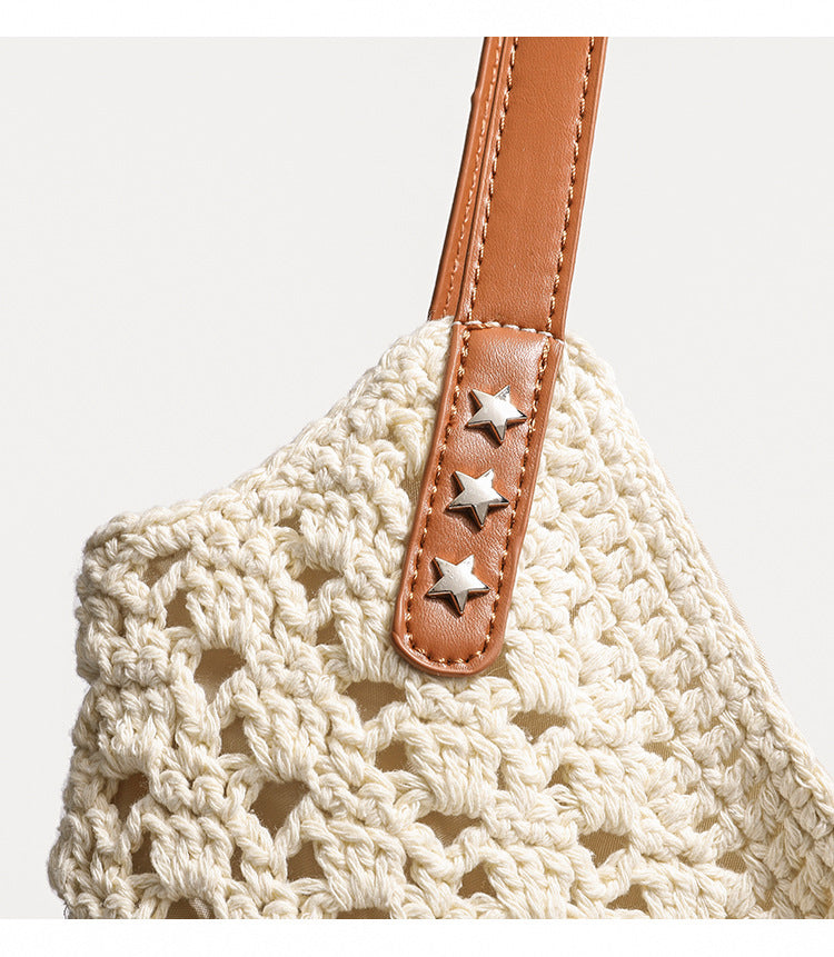 Cream openwork crochet tote bag with tan leather-look double shoulder straps and tassel drawstring tie, detail view 9