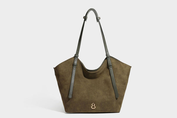 Oversized suede-finish tote shoulder bag in caramel brown with slim leather-look straps and gold-tone logo hardware, detail