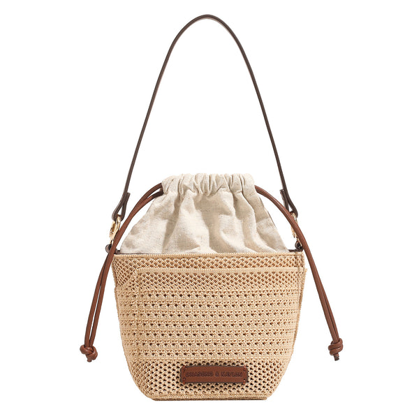 Compact openwork woven bucket bag with gathered cream drawstring liner, leather-look brown trim and cords, and gold-tone