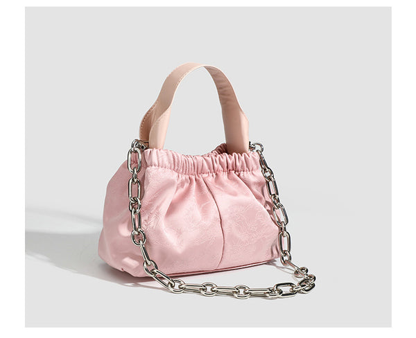 Small ruched satin-finish cloud bag with elasticized drawstring top, short top handle, and chunky silver-tone chain strap