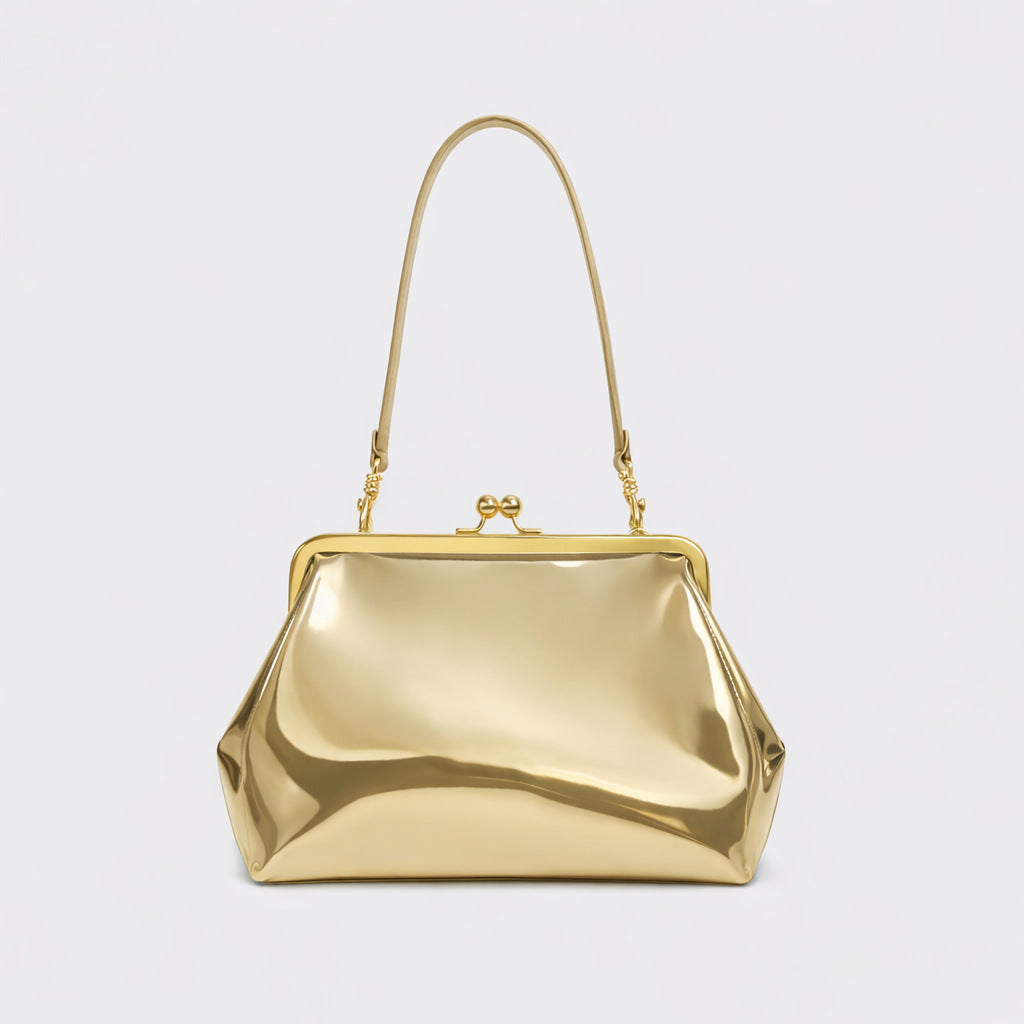 Trapezoid kiss-lock frame shoulder bag with gold-tone hardware and slim adjustable strap, front view
