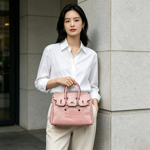 Croc-embossed structured trapezoid satchel with silver turn-lock hardware, rounded top handles, and detachable shoulder