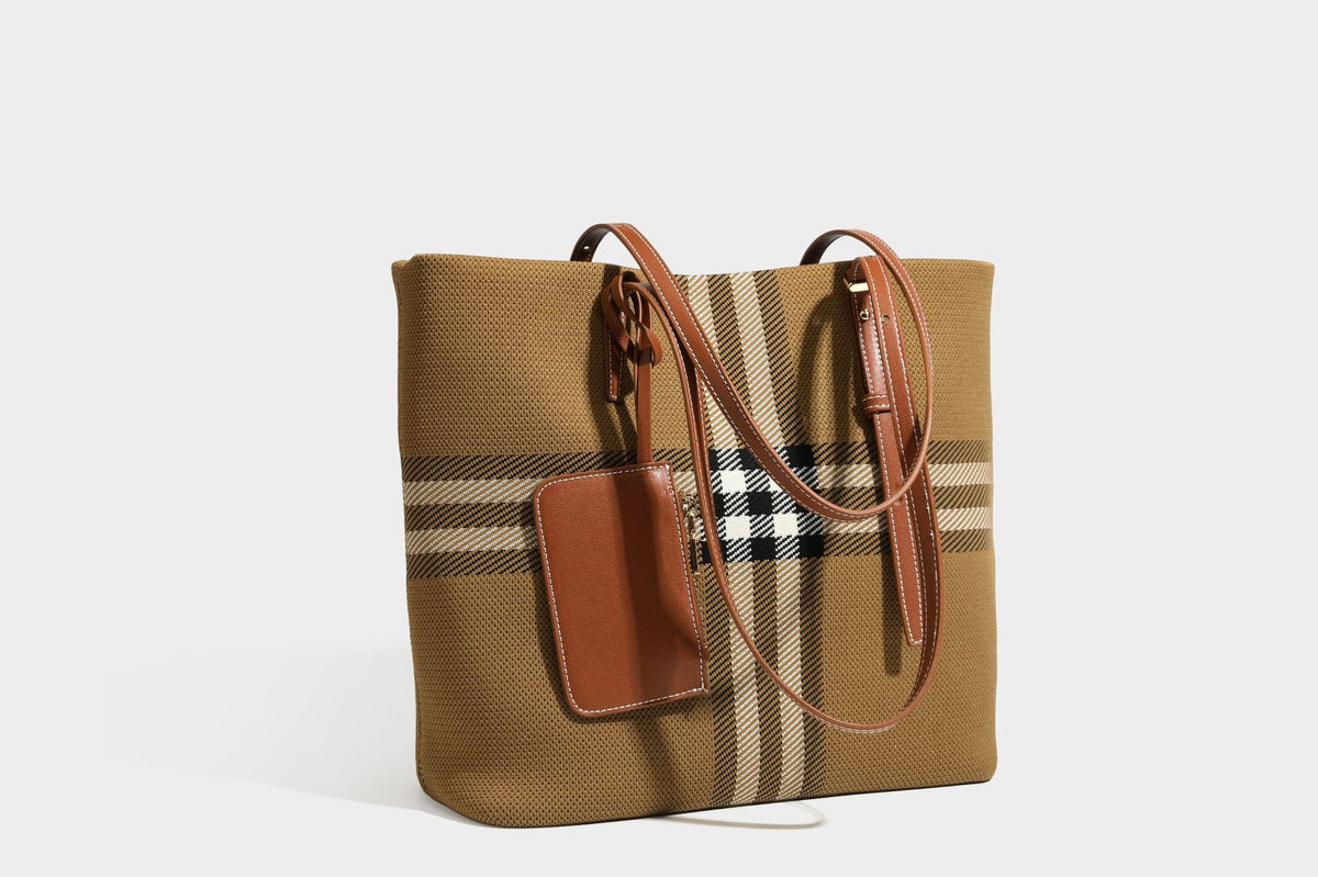 Large structured plaid check tote bag with smooth tan leather-look shoulder straps, attached front zip pouch, and gold-tone