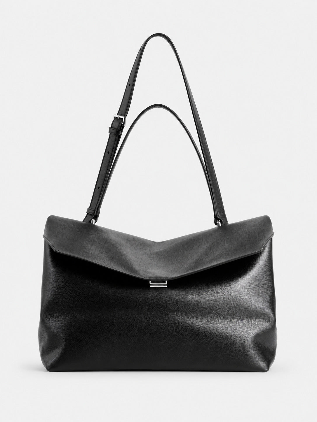 Large black slouchy leather-look shoulder bag with V-shaped envelope flap, silver-tone clasp, and adjustable strap, detail