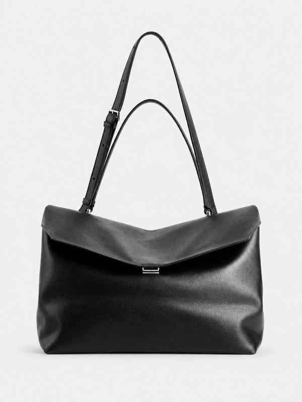 Large black slouchy leather-look shoulder bag with V-shaped envelope flap, silver-tone clasp, and adjustable strap, detail