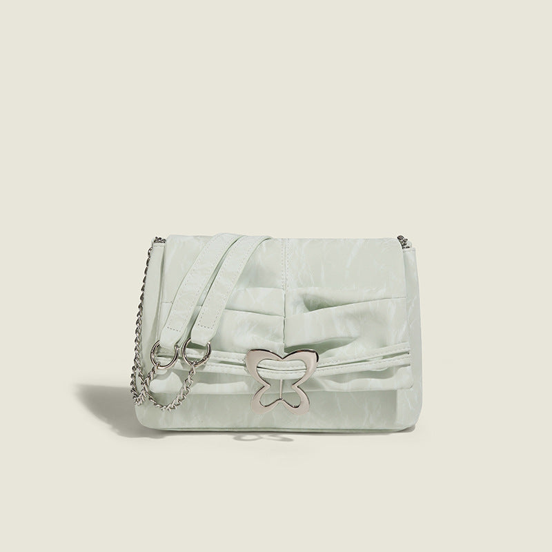 Structured rectangular chain shoulder bag with silver butterfly clasp and glossy crinkled finish, detail view 6
