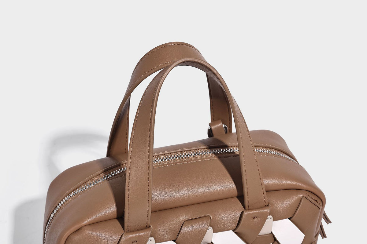 Small structured satchel bag with two-tone woven front panel, dual top handles, and detachable crossbody strap in tan brown
