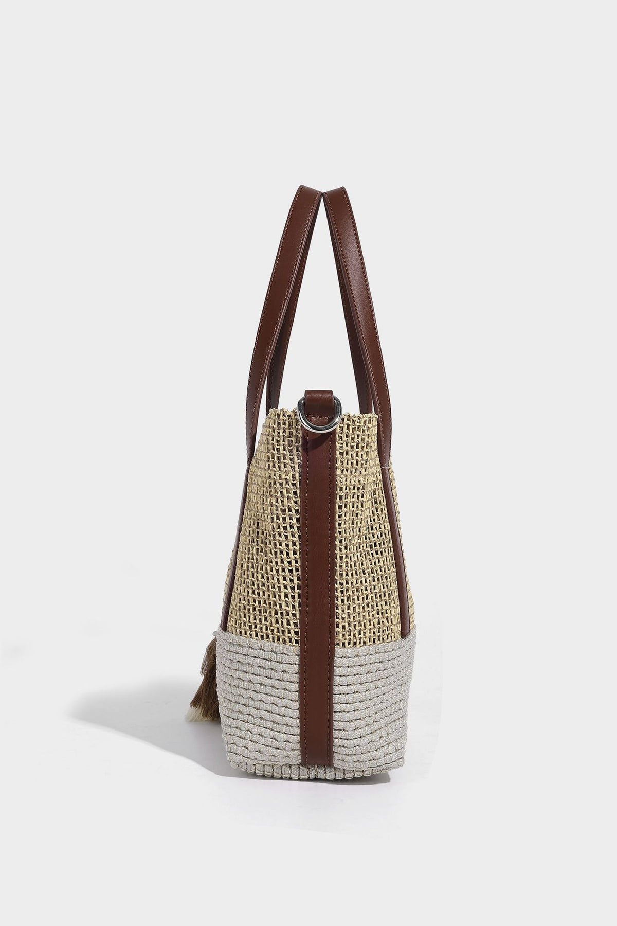 Two-tone open-weave tote bag in beige and cream with brown leather-look handles, tassel bead charm, and detachable