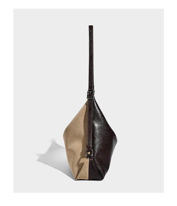 Slouchy hobo tote bag with matte leather-look finish, triangular silhouette, front zip pocket, and adjustable shoulder strap