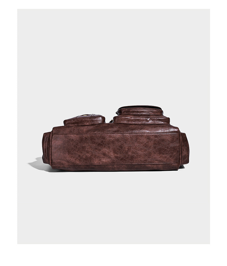 Distressed leather-look vintage satchel shoulder bag with multiple front zip pockets, dual top handles, and brass-tone