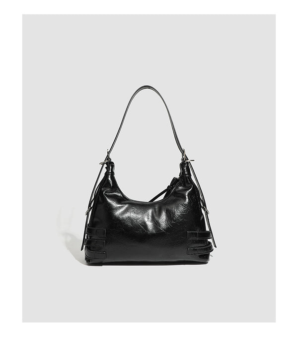 Slouchy hobo shoulder bag in glossy crinkled leather-look finish with silver-tone buckle hardware and slim adjustable strap
