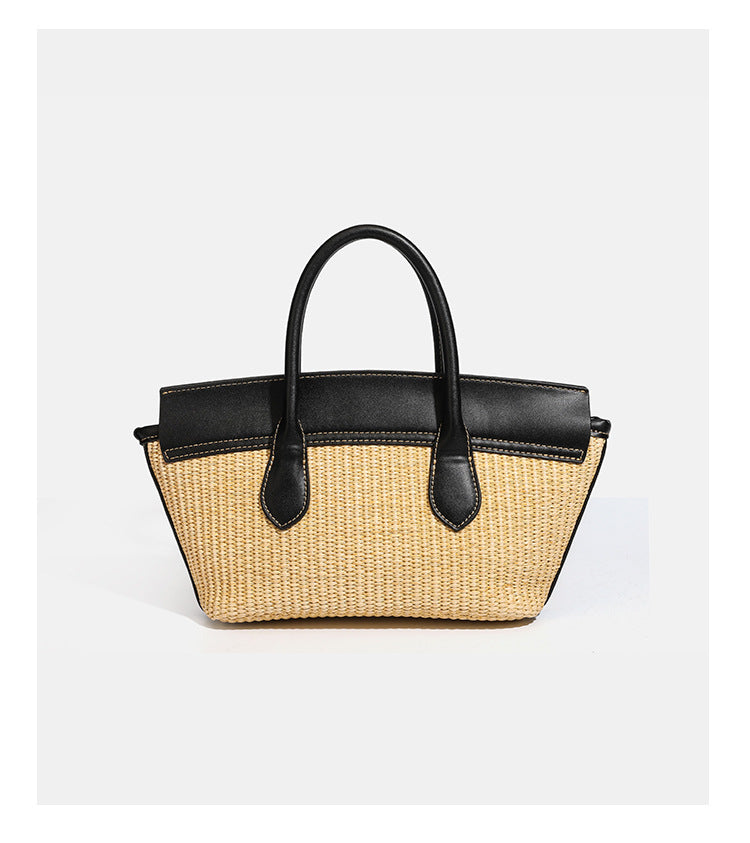 Structured tan woven straw tote bag with black leather-look trim, twin rounded top handles, gold-tone turn-lock front flap