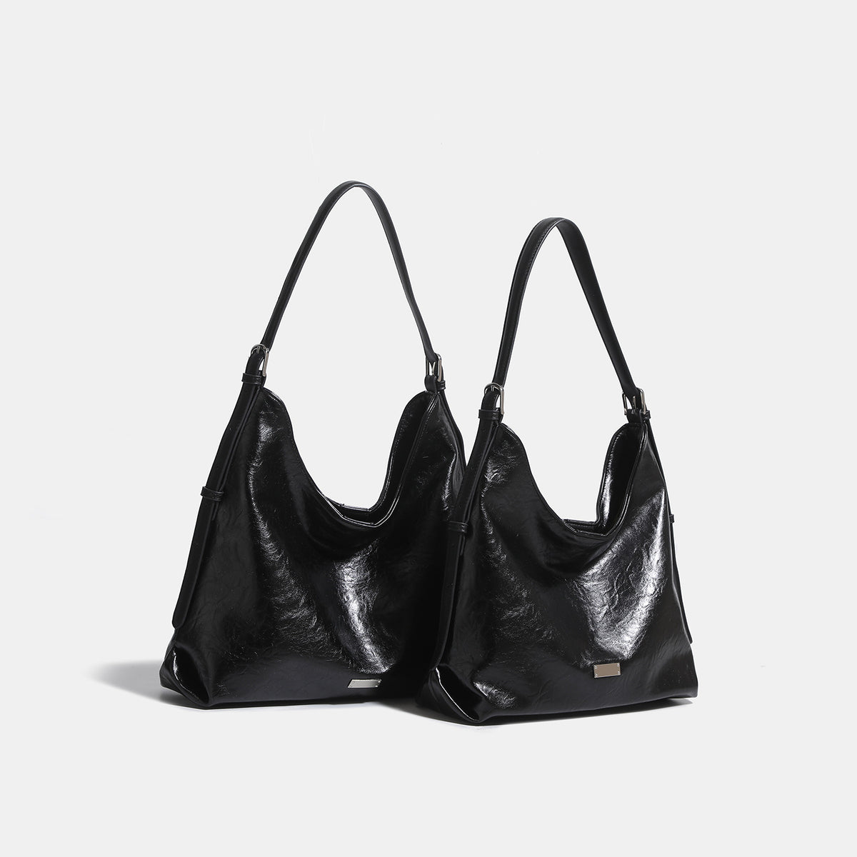 Slouchy hobo shoulder bag with glossy wrinkled leather-look finish, adjustable strap, and snap closure, detail view 3