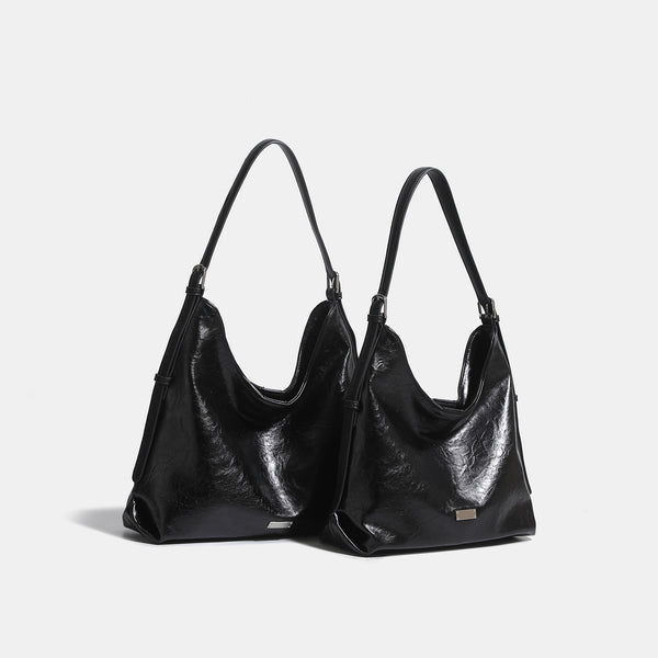 Slouchy hobo shoulder bag with glossy wrinkled leather-look finish, adjustable strap, and snap closure, detail view 3