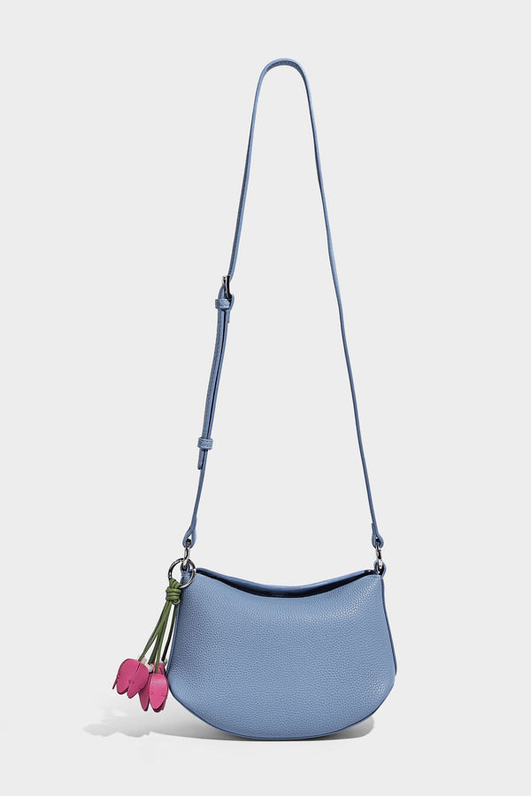 Small crescent half-moon bag in pebbled leather-look finish with braided top handle, silver-tone ring hardware, and, detail