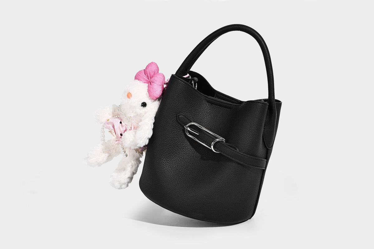 Mini pebbled leather-look bucket bag with front buckle strap, silver-tone hardware, top handle, and detachable shoulder
