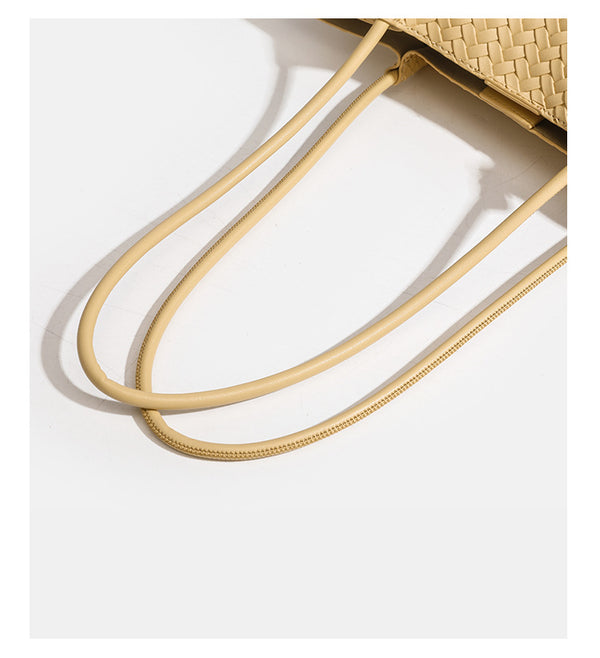 Woven leather-look tote bag in yellow with long shoulder straps, heart-shaped hanging charm, and removable inner zip pouch