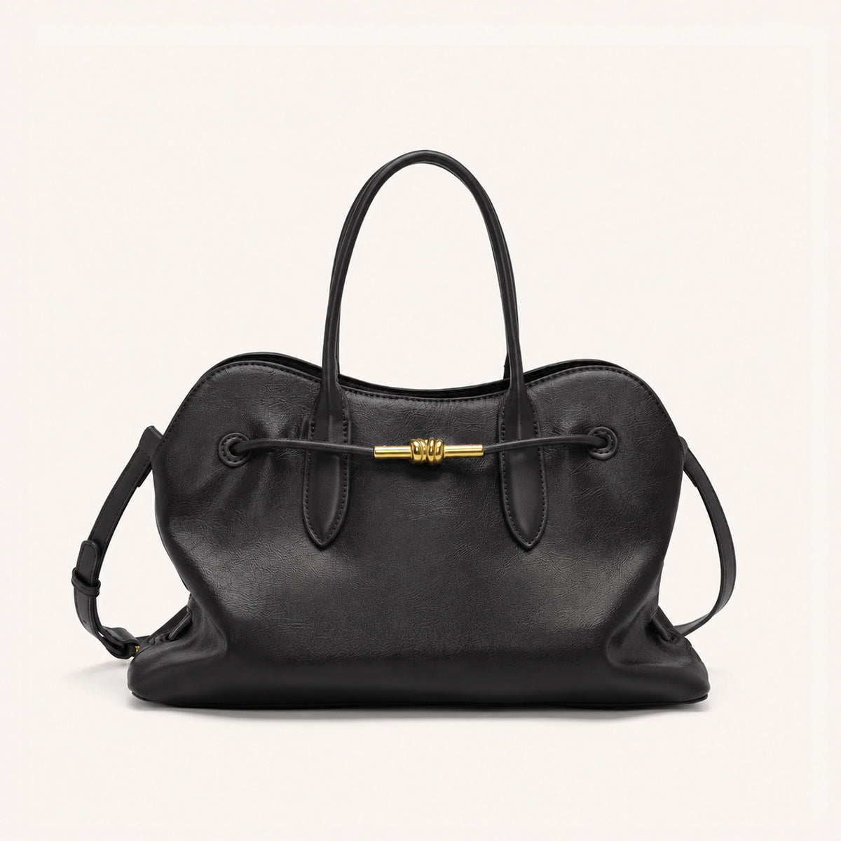Dark brown leather-look slouchy satchel bag with dual rolled top handles, drawstring front, and antique gold-tone bar, detail
