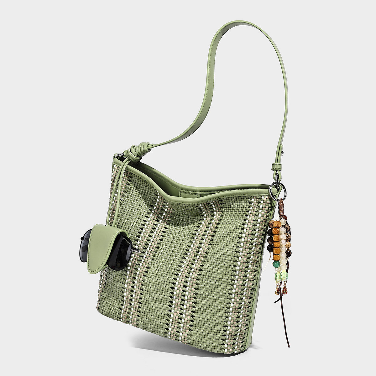 Woven bucket shoulder bag with leather-look trim, silver-tone hardware, and beaded tassel charm, detail view 6