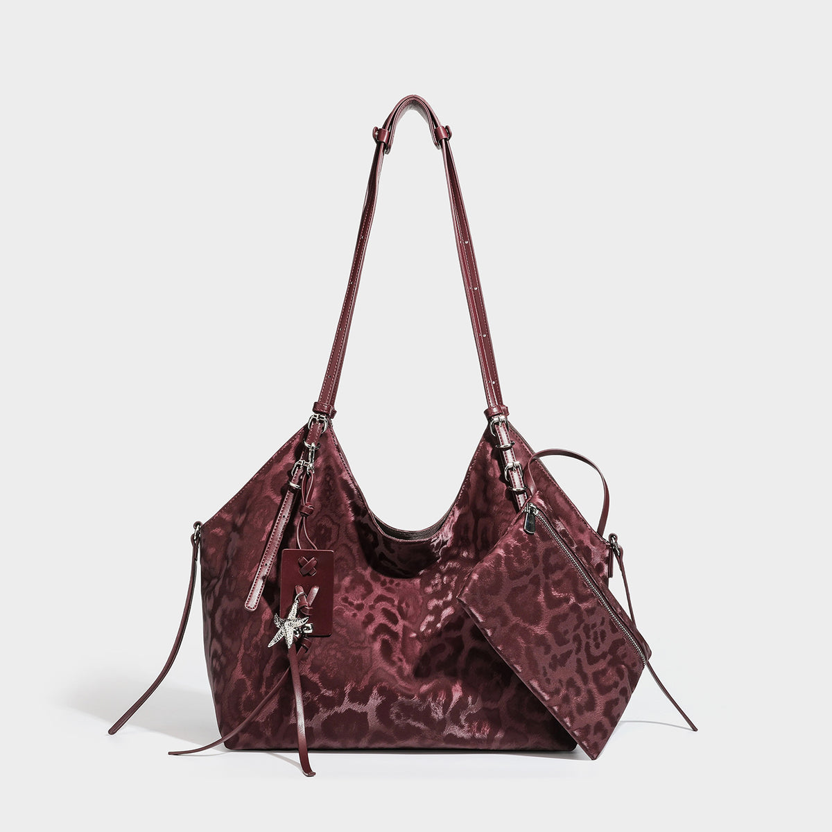Large glossy leopard-print hobo shoulder bag with detachable zip pouch and silver-tone starfish charm hardware, detail view 2