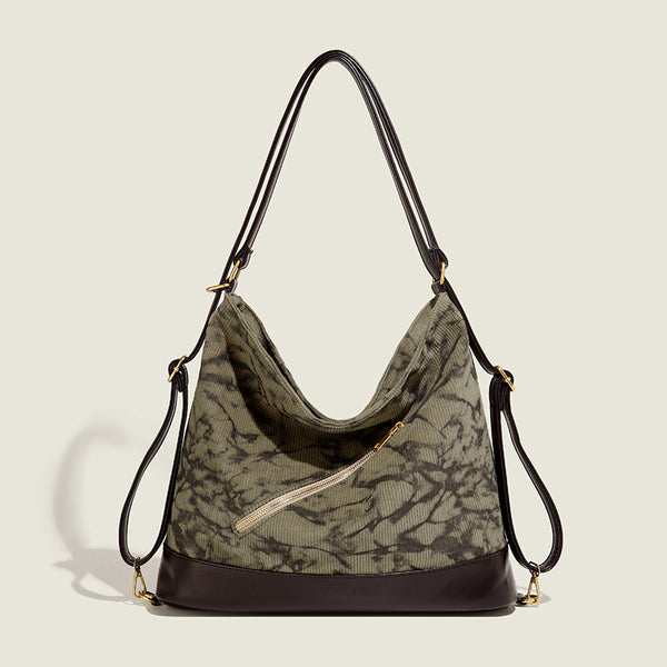 Large ink-wash printed corduroy hobo bag with dark brown leather-look base trim, diagonal front zip pocket, and gold-tone