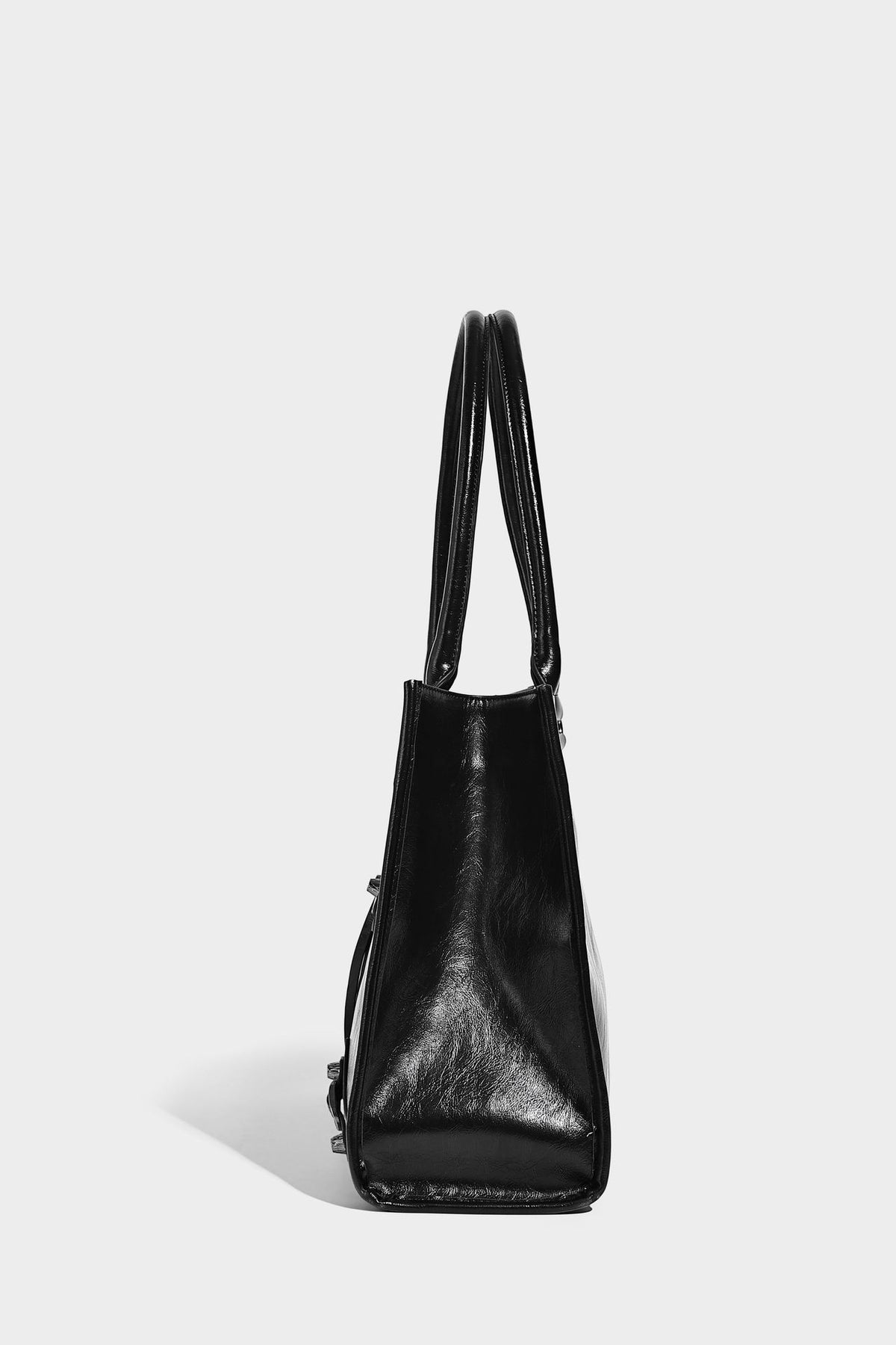 Large structured leather-look tote bag with front zip pocket, moto hardware accents, and long double shoulder straps, detail