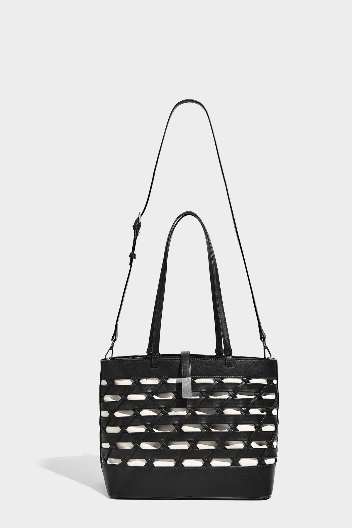 Structured woven lattice cutout tote bag with smooth leather-look trim, dual shoulder straps, and silver-tone hardware