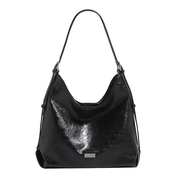 Slouchy hobo shoulder bag with glossy wrinkled leather-look finish, adjustable strap, and snap closure, detail view 5