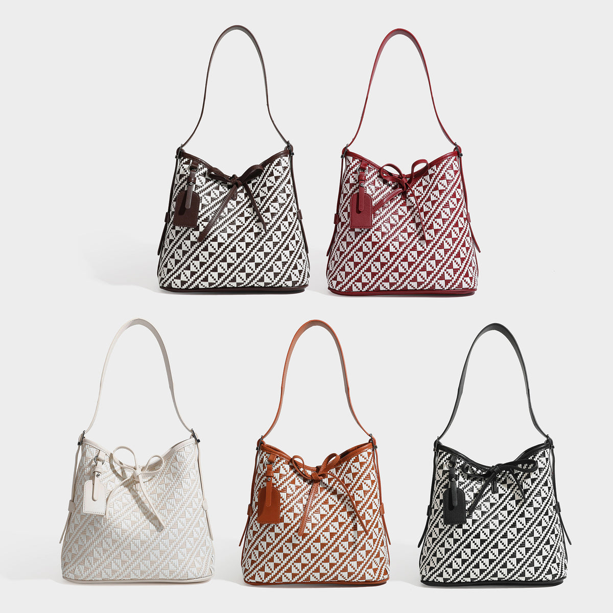 Woven geometric bucket shoulder bag in white and dark brown two-tone pattern with leather-look trim and drawstring top