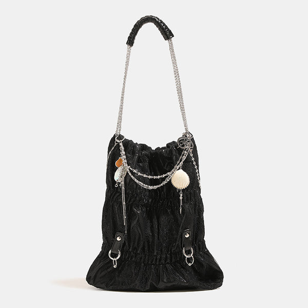 Slouchy lace-texture bucket bag with silver-tone chain strap, draped chain hardware, and shell charms, detail view 9