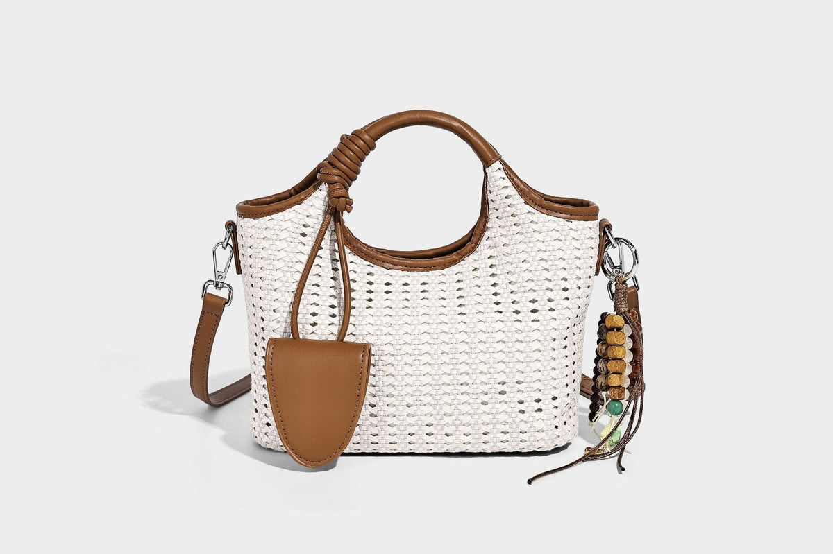 Small structured woven tote crossbody bag with ring top handle, leather-look brown trim, front patch pocket, and detachable