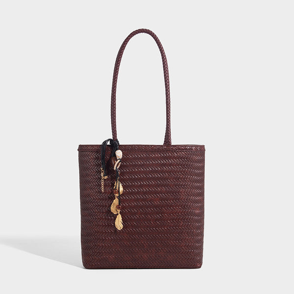 Structured woven herringbone tote bag with braided double shoulder handles in tan brown, shown with matching drawstring