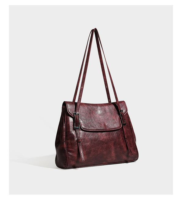 Structured flap-top shoulder tote bag in distressed leather-look finish with silver-tone buckle hardware and double shoulder