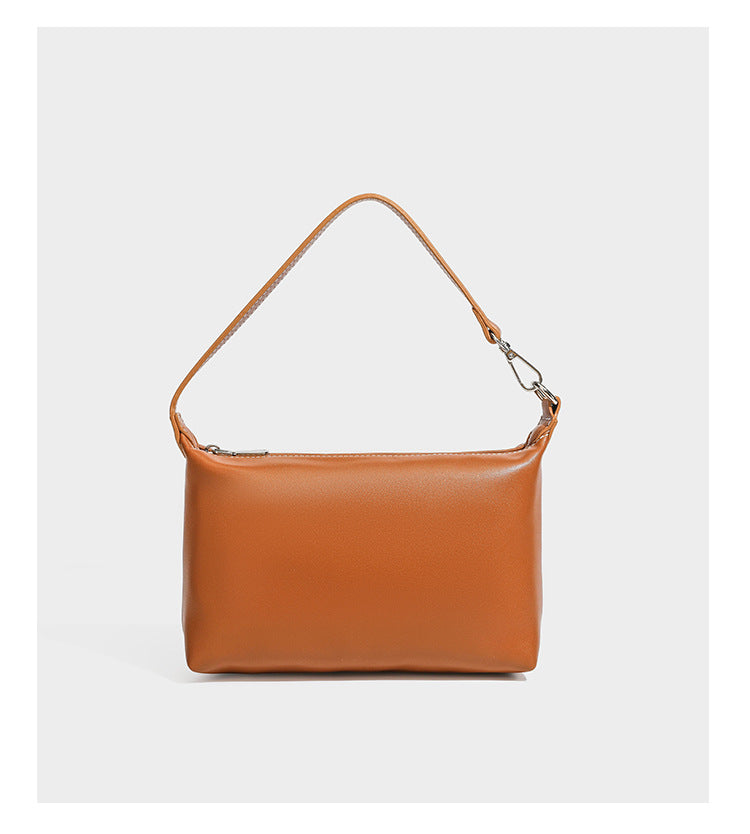 Large cream and navy striped canvas bucket tote bag with tan leather-look trim, drawstring closure, and double shoulder