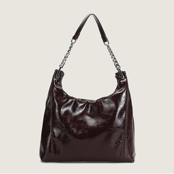Glossy crinkled leather-look slouchy hobo bag with silver chain-and-leather shoulder strap and open top, front view