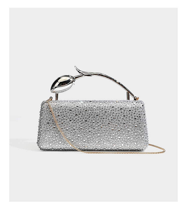 rectangular hard-case rhinestone evening clutch with sculptural gold-tone branch-and-bud top handle and detachable chain