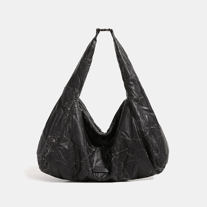 Oversized slouchy hobo shoulder bag in dark marled denim-texture fabric with top zip closure and adjustable single strap