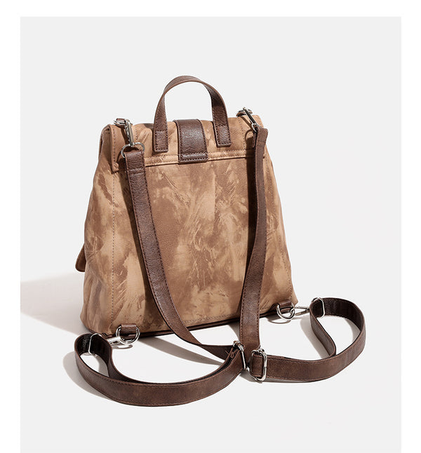 Compact distressed leather-look tan-brown backpack handbag with flap-and-buckle closure, two front patch pockets, top handle