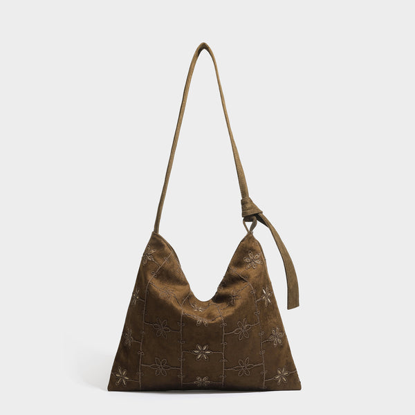 Lässig weich fallende Hobo-Schultertasche in dunkelbrauner Velourslederoptik mit Ton-in-Ton-Blumenstickerei und langem, geknotetem Einzelriemen, Detailansicht