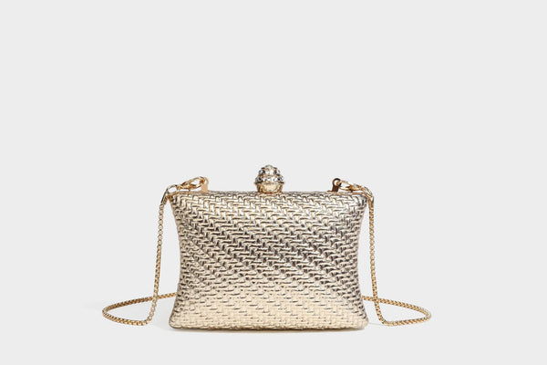 Small structured rectangular metallic woven-texture clutch bag with jeweled knob clasp and gold-tone chain strap, detail view