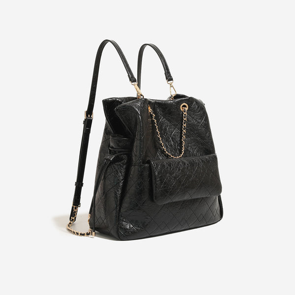 Large quilted leather-look drawstring backpack handbag with gold-tone chain handles and front flap pocket, detail view 7