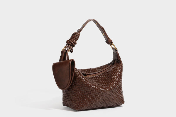 Small glossy basket-weave hobo shoulder bag in brown with knotted top handle, flap accent pocket, and gold-tone hardware