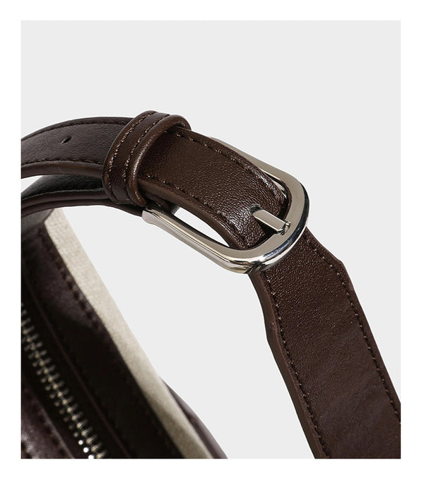 Lässig geschnittene Hobo-Schultertasche aus Canvas in Haferflockenfarbe mit dunkelbraunem Besatz in Lederoptik, silberfarbenem Reißverschluss und langem, verstellbarem