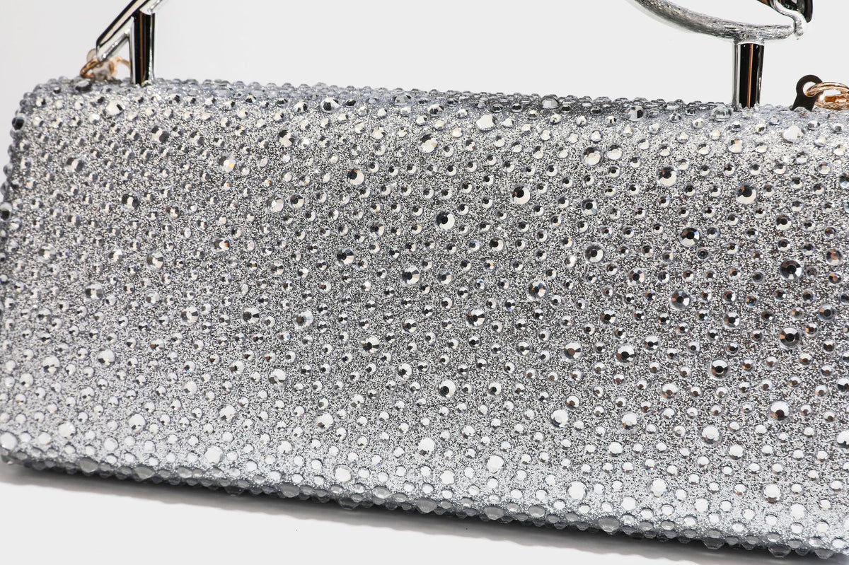 rectangular hard-case rhinestone evening clutch with sculptural gold-tone branch-and-bud top handle and detachable chain